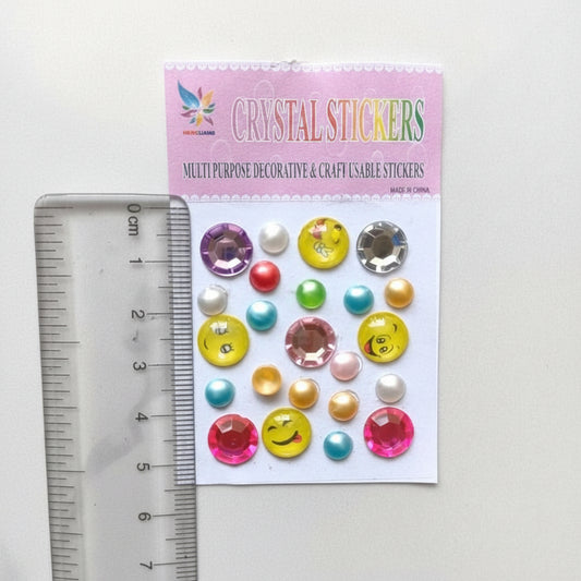 Sheet of colorful decorative stickers with a ruler for scale on a white background